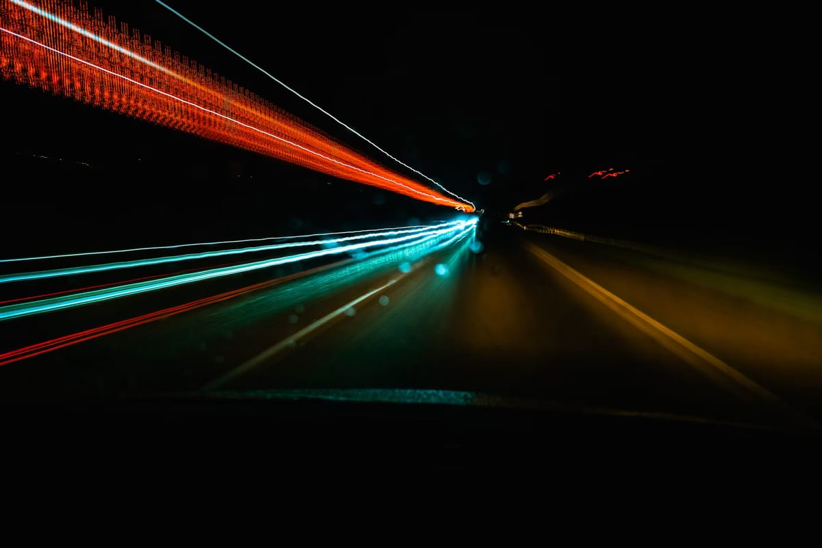Light trails from fast-moving vehicles at night