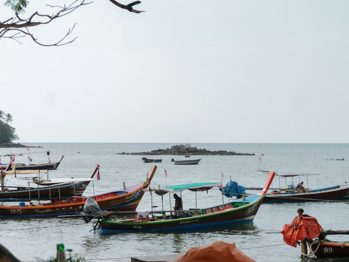 Traditional long-tail boats anchored in clear sea water